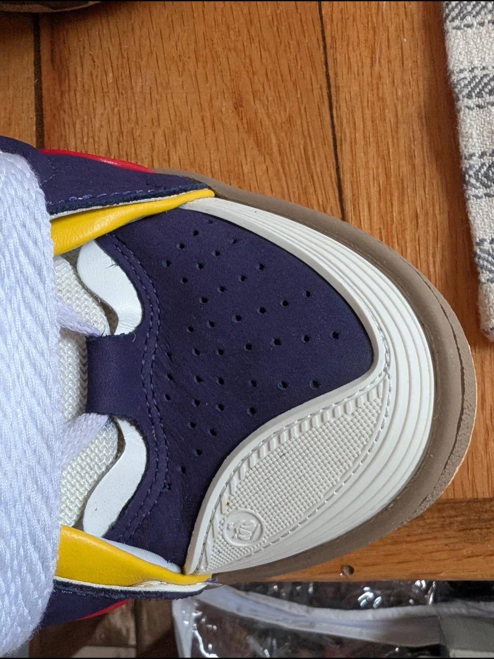 Lanvin Curb Sneakers in a distinct Navy Blue, White, Red, and Yellow colorway.
